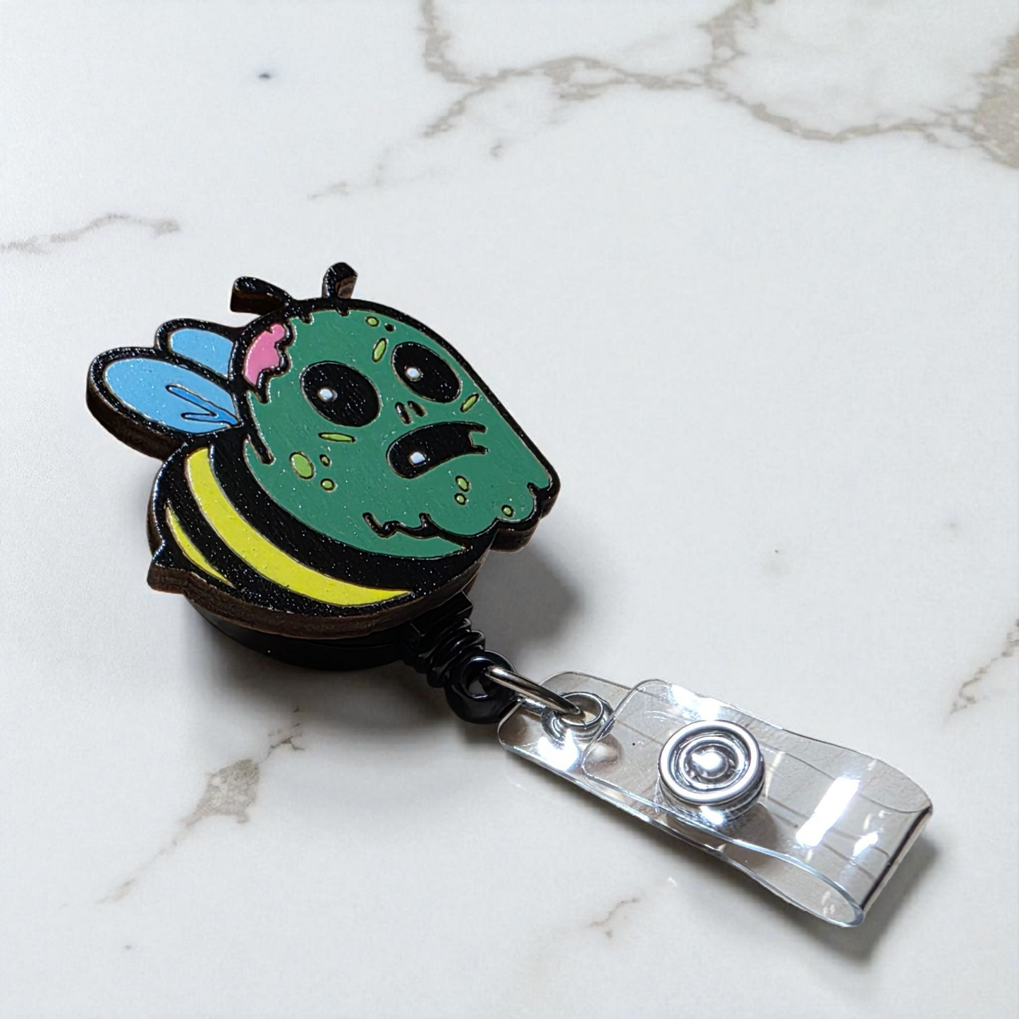 π§ββοΈ Zom-Bee Badge Reel β Hand-Painted